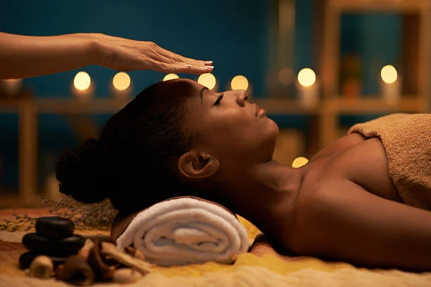 Clients resting during a hot stone treatment with candles nearby