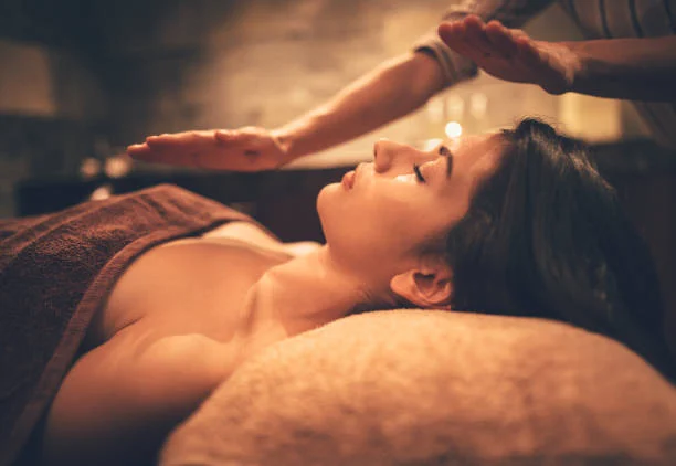 A client lying on a massage table during a relaxing treatment